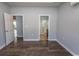 A bedroom featuring wood floors and doorways to the bathroom and hallway at 107 Carolines Cove Ct., Myrtle Beach, SC 29588