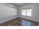 Comfortable bedroom with wood floors, natural light, and a mini-split air conditioner at 107 Carolines Cove Ct., Myrtle Beach, SC 29588