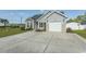 Charming home with gray siding, a spacious driveway, and attached garage at 107 Carolines Cove Ct., Myrtle Beach, SC 29588