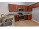 Stylish kitchen with granite countertops, stainless steel appliances, and dark wood cabinetry at 107 Carolines Cove Ct., Myrtle Beach, SC 29588