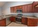 Modern kitchen featuring stainless steel appliances, granite countertops, and dark wood cabinets at 107 Carolines Cove Ct., Myrtle Beach, SC 29588