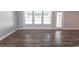 Spacious living room showcasing wood floors, large windows, and ample natural light at 107 Carolines Cove Ct., Myrtle Beach, SC 29588