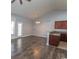 Open living area with vaulted ceilings, light fixtures, wood floors, and access to the patio at 107 Carolines Cove Ct., Myrtle Beach, SC 29588