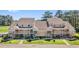 Exterior view of townhomes featuring private entrances and manicured landscaping, perfect for relaxation and entertainment at 1095 Plantation Dr. W # 29 N, Little River, SC 29566