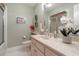 Stylish bathroom with framed mirror, flowers, and a glass door shower at 124 Windmeadows Dr., Conway, SC 29526