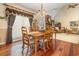 Dining area featuring hardwood floors, a chandelier, and a view into the adjacent living room at 124 Windmeadows Dr., Conway, SC 29526