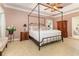 Bright primary bedroom with four-post bed, plush carpeting, and ample natural light at 124 Windmeadows Dr., Conway, SC 29526
