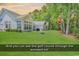 Well-maintained backyard with a glimpse of the golf course through the trees at 1249 Trent Dr., Murrells Inlet, SC 29576