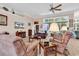 Bright living room with 12 foot ceilings and a ceiling fan, showing natural light from large windows at 1249 Trent Dr., Murrells Inlet, SC 29576