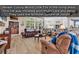 Spacious living room featuring wood-look tile flooring, large windows, and comfortable seating at 1249 Trent Dr., Murrells Inlet, SC 29576