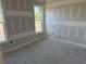 This bedroom features new drywall, large windows with trim, and ample natural light ready for décor at 135 Stonewall Circle # 7-2, Longs, SC 29568