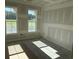 This bedroom boasts two large windows, new drywall, and ample natural light ready for décor at 135 Stonewall Circle # 7-2, Longs, SC 29568