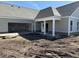New construction home with an open garage and a covered front porch, featuring a neutral color palette at 135 Stonewall Circle # 7-2, Longs, SC 29568