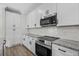 Updated kitchen features stainless appliances, white cabinets, granite countertops, and subway tile backsplash at 135 Stonewall Circle # 7-2, Longs, SC 29568