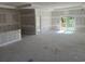 Spacious living room with a sliding glass door and fresh drywall ready for custom finishes at 135 Stonewall Circle # 7-2, Longs, SC 29568