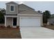 Two-story home with an attached garage and a concrete driveway at 135 Warner Crossing Way, Loris, SC 29569