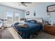 Bright bedroom with ceiling fan, double doors, and a comfortable bed at 1411 Turkey Ridge Rd. # 30-B, Surfside Beach, SC 29575