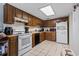 Functional kitchen with wooden cabinets, white appliances, and tile flooring at 1411 Turkey Ridge Rd. # 30-B, Surfside Beach, SC 29575