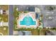 Community pool and lounge area with chairs and tables surrounded by palm trees in an aerial view at 1512 Virginia Pine Dr., Longs, SC 29568