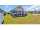 Expansive backyard featuring a screened-in porch, lush lawn, and meticulous landscaping at 1512 Virginia Pine Dr., Longs, SC 29568