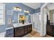 Bathroom with a walk-in shower, double vanity, and decorative yellow flower arrangement at 1512 Virginia Pine Dr., Longs, SC 29568