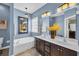 Bright bathroom with a soaking tub, double vanity, and elegant lighting fixtures at 1512 Virginia Pine Dr., Longs, SC 29568