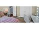 Cozy bedroom featuring a vanity, white chair, and pink bedding at 1512 Virginia Pine Dr., Longs, SC 29568