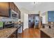 Well-equipped kitchen featuring stainless steel appliances, dark wood cabinets and ample counter space at 1512 Virginia Pine Dr., Longs, SC 29568