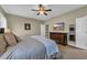 Well-lit main bedroom featuring a dresser, television, and comfortable carpeting at 1512 Virginia Pine Dr., Longs, SC 29568