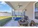 Inviting screened-in porch with outdoor seating, a fire pit, and tranquil views at 1512 Virginia Pine Dr., Longs, SC 29568