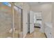 Modern bathroom with a glass-enclosed shower with a bench, double doors and vanity with sink at 1525 Seachase Way, North Myrtle Beach, SC 29582