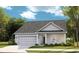 Charming one-story home featuring a covered porch, attached garage and manicured lawn and inviting curb appeal at 1525 Seachase Way, North Myrtle Beach, SC 29582
