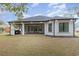 This backyard boasts a covered patio, a built-in grill, and luscious lawn at 1559 Old Tram Rd., Little River, SC 29566