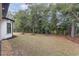 This backyard features a large grassy area and a wood line at 1559 Old Tram Rd., Little River, SC 29566
