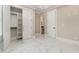 Open bedroom leading to a closet and bathroom, featuring marble floors, and light walls at 1559 Old Tram Rd., Little River, SC 29566