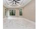 A bright, modern bedroom featuring high ceilings, large windows, and clean, marble-style floors at 1559 Old Tram Rd., Little River, SC 29566