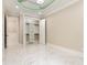 Sunlit bedroom with a walk-in closet and views of the connecting rooms, and bright marble floors at 1559 Old Tram Rd., Little River, SC 29566