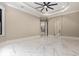 An open bedroom with marble floors leading to the kitchen and an arched doorway at 1559 Old Tram Rd., Little River, SC 29566