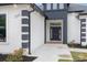 Up-close view of the black front door with decorative accents and modern white and black trim at 1559 Old Tram Rd., Little River, SC 29566