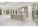 Bright open-plan kitchen with gray cabinets, white marble counters and island, and modern pendant lighting at 1559 Old Tram Rd., Little River, SC 29566