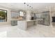 A modern kitchen featuring an island, stainless steel appliances, marble countertops, and gray cabinets at 1559 Old Tram Rd., Little River, SC 29566