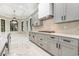 A sleek kitchen with gray cabinets, marble backsplash and countertops, with a gas range stove at 1559 Old Tram Rd., Little River, SC 29566