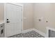 This laundry room features sleek black and white patterned floors and neutral walls at 1559 Old Tram Rd., Little River, SC 29566