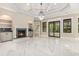 Spacious living room features a fireplace, recessed lighting, and large windows that illuminate the marble floors at 1559 Old Tram Rd., Little River, SC 29566