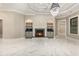 Bright living room with a cozy fireplace, built-in shelving, and gleaming marble floors, perfect for entertaining at 1559 Old Tram Rd., Little River, SC 29566