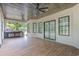 This covered patio features wood look tile floors, a built in grill, and several ceiling fans at 1559 Old Tram Rd., Little River, SC 29566