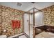 This bathroom has a glass shower, large tub, and floral wallpaper at 1625 S Ocean Blvd. # 1604, North Myrtle Beach, SC 29582