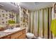 This bathroom features a shower with curtain and vanity with sink at 1625 S Ocean Blvd. # 1604, North Myrtle Beach, SC 29582
