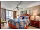 Cozy bedroom with a four-poster bed and balcony access overlooking the ocean at 1625 S Ocean Blvd. # 1604, North Myrtle Beach, SC 29582