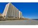 View of towering beachside condos from the sandy shore on a bright, sunny day at 1625 S Ocean Blvd. # 1604, North Myrtle Beach, SC 29582